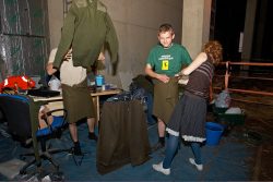 Grzegorz is fitted for his kilt by Lise Marker while Artur throws his sweater into the air.