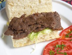 Scottish | Kobe beef, cut 8mm thick, marinated in teriyaki sauce, and cooked briefly on the barbeque. Served with some fresh tomatoes, and on a fresh roll.